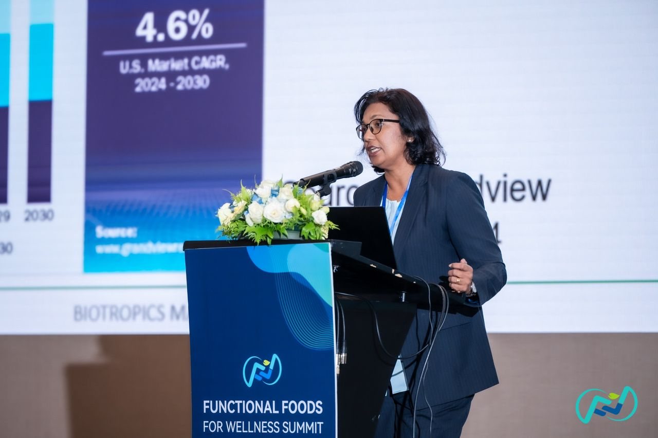 Dr Annie George speaking at a podium at the Functional Foods for Wellness Summit